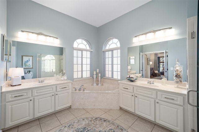 bathroom with tile patterned flooring, vanity, and plus walk in shower