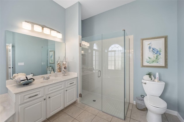 bathroom with vanity, toilet, tile patterned floors, and walk in shower