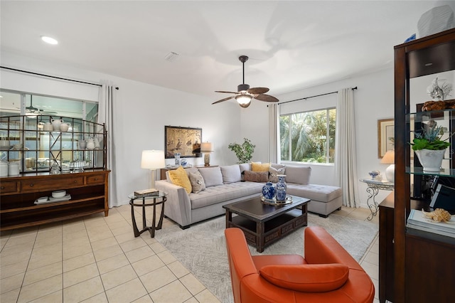 living room featuring light tile patterned floors and ceiling fan