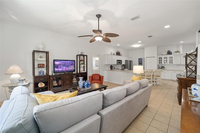 living room with ceiling fan and light tile patterned floors