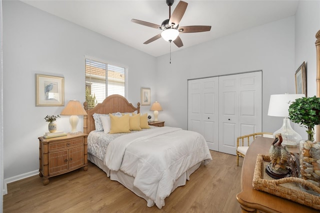 bedroom featuring ceiling fan, light hardwood / wood-style floors, and a closet