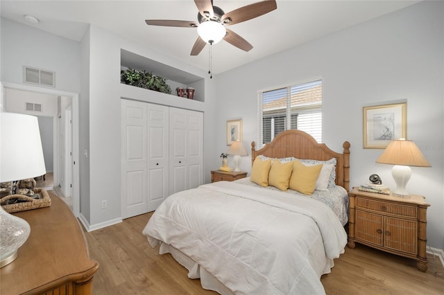 bedroom with a closet, ceiling fan, and light hardwood / wood-style flooring