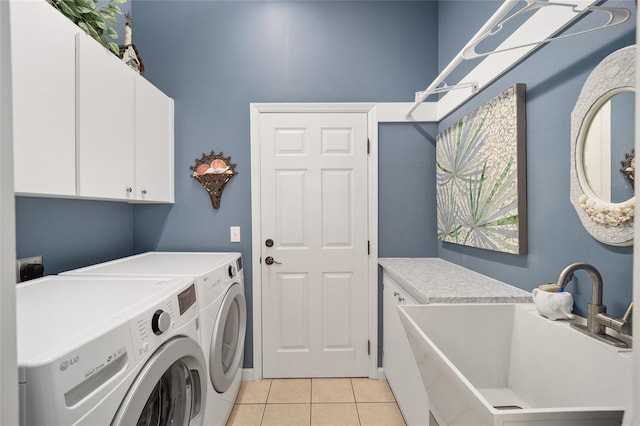 laundry room with washer and dryer, sink, cabinets, and light tile patterned flooring