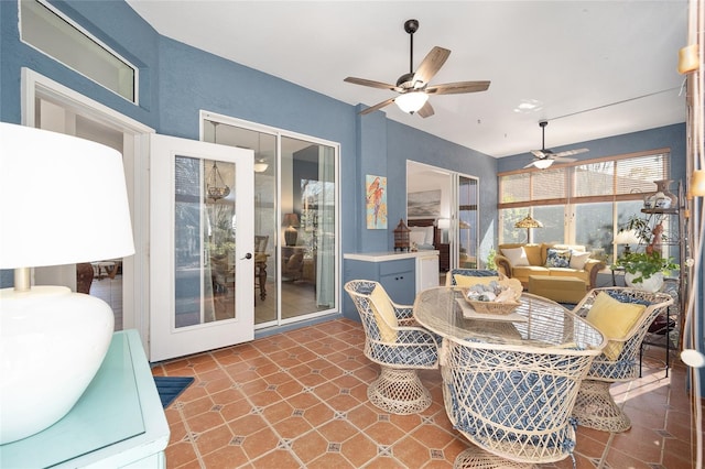 sunroom featuring ceiling fan