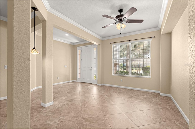 spare room featuring ceiling fan, crown molding, and a textured ceiling