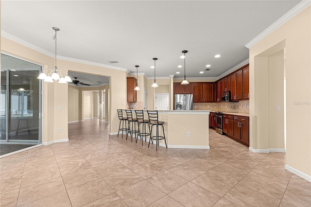 kitchen featuring ornamental molding, appliances with stainless steel finishes, a kitchen breakfast bar, and hanging light fixtures