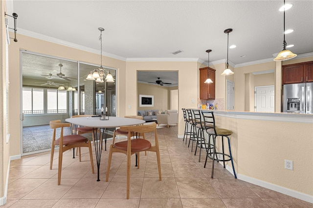 dining room featuring ceiling fan, ornamental molding, and light tile patterned floors