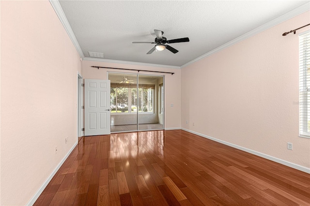 unfurnished room with a textured ceiling, wood-type flooring, ornamental molding, and ceiling fan