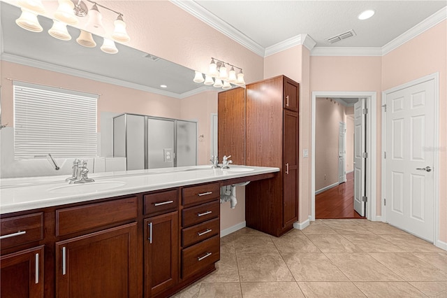 bathroom featuring ornamental molding, vanity, tile patterned floors, and walk in shower