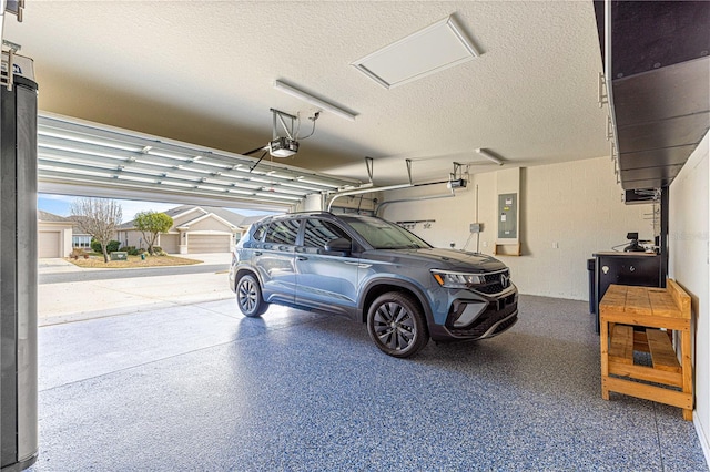 garage with a garage door opener and electric panel