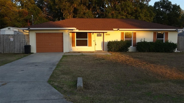 single story home featuring a garage and a front yard