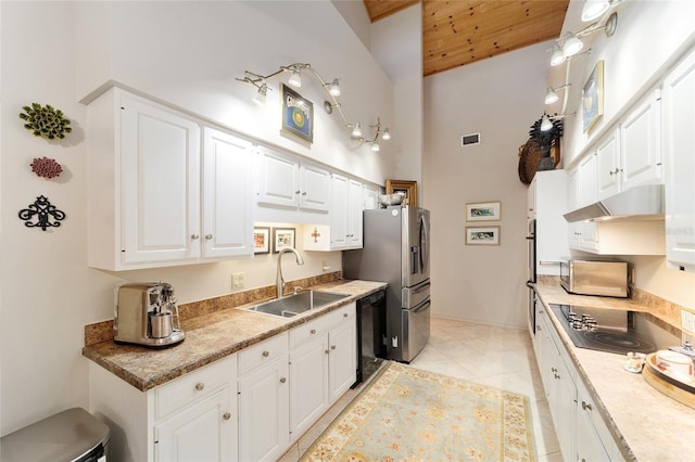 kitchen featuring light tile patterned flooring, sink, white cabinetry, a towering ceiling, and black appliances