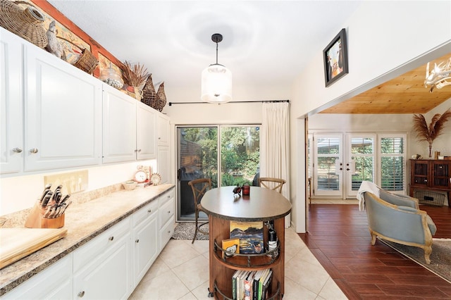 kitchen with white cabinetry, a healthy amount of sunlight, and pendant lighting