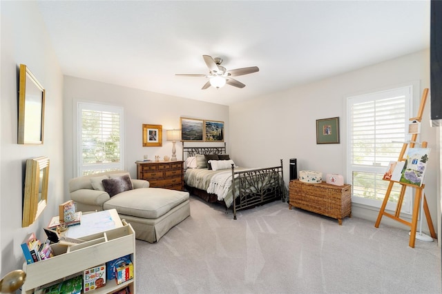 bedroom featuring light carpet and ceiling fan