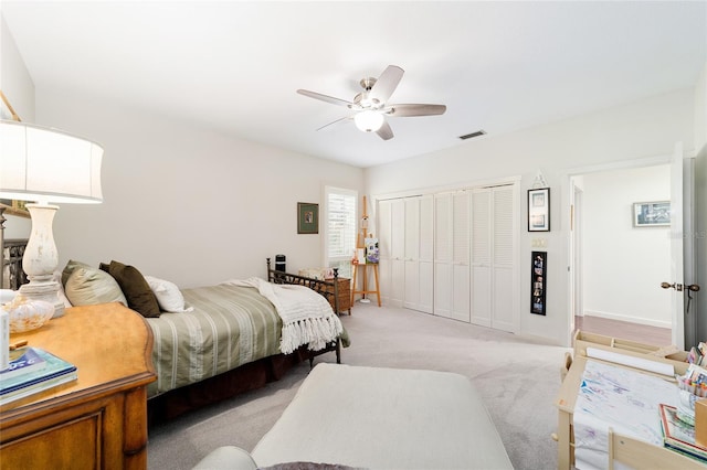 bedroom with light carpet, a closet, and ceiling fan