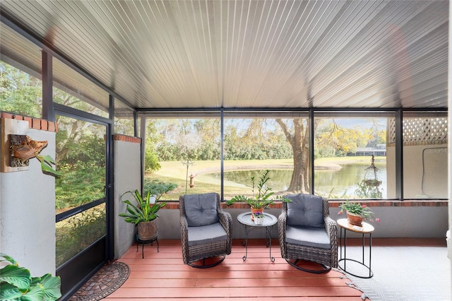 sunroom featuring a healthy amount of sunlight and a water view