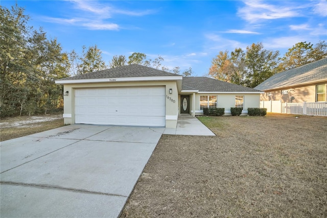 single story home featuring a garage and a front lawn