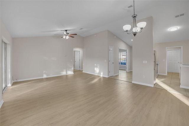 unfurnished living room with lofted ceiling, ceiling fan with notable chandelier, and light hardwood / wood-style flooring