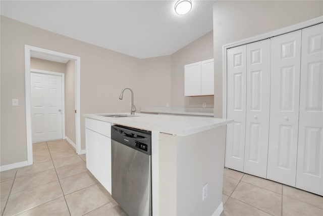 kitchen with white cabinetry, dishwasher, a kitchen island with sink, and light tile patterned floors