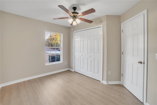 unfurnished bedroom with a closet, ceiling fan, and light wood-type flooring