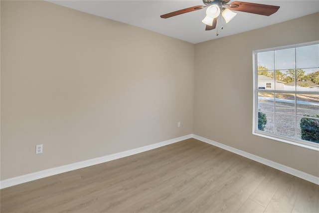 unfurnished room featuring ceiling fan, plenty of natural light, and light wood-type flooring