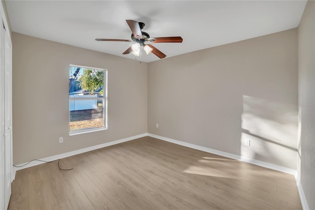 empty room featuring ceiling fan and light hardwood / wood-style flooring