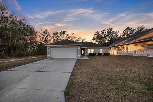 view of front of house featuring a garage and a yard