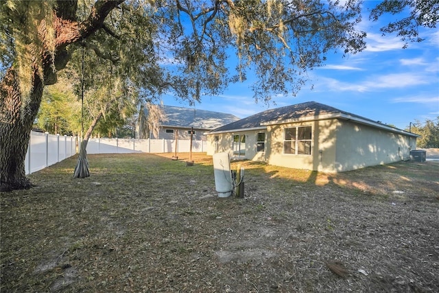 exterior space with a yard and central AC