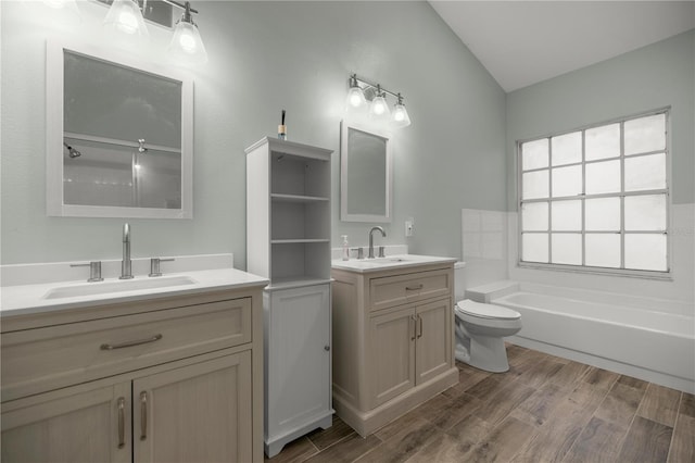 bathroom with wood finished floors, a sink, and toilet