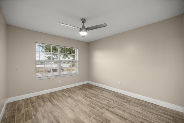 empty room featuring light wood-style floors, ceiling fan, and baseboards