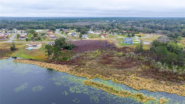 bird's eye view featuring a residential view, a water view, and a wooded view