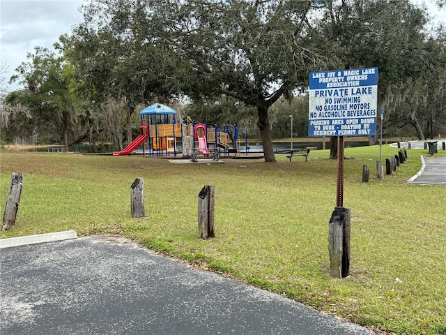 community jungle gym featuring a yard