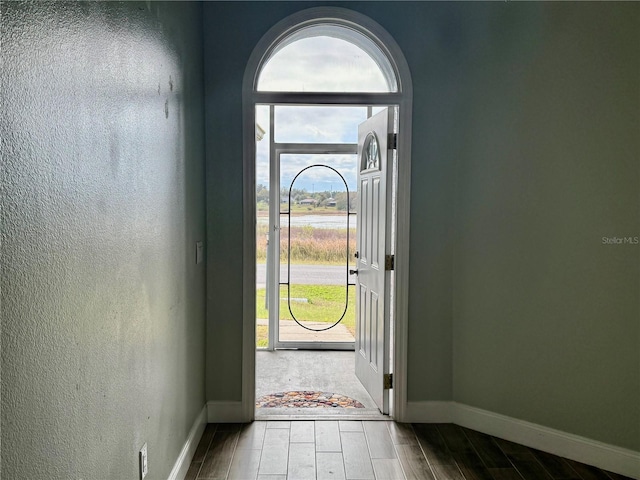 entrance foyer with wood tiled floor and baseboards