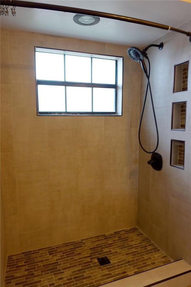 bathroom with a tile shower