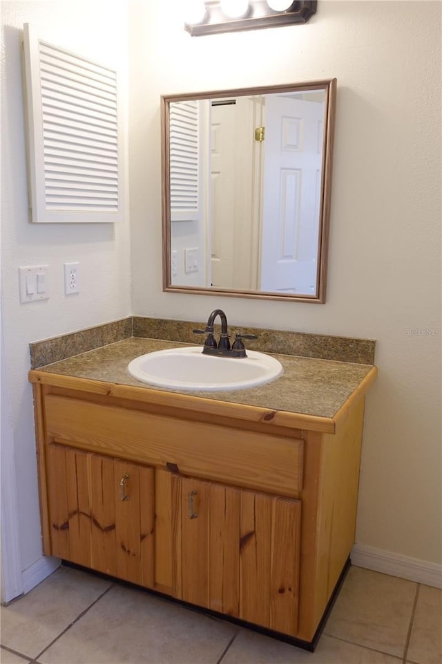 bathroom with tile patterned flooring and vanity