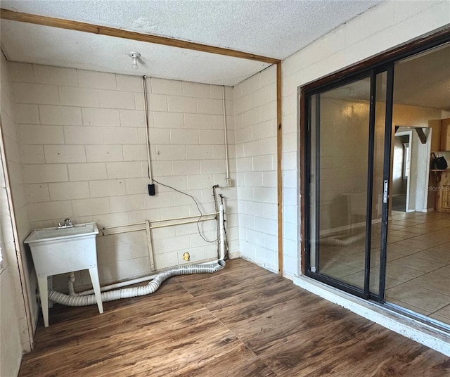 laundry area featuring hardwood / wood-style floors and a textured ceiling