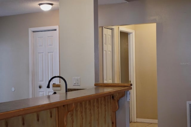 interior space featuring sink, tile patterned floors, and a textured ceiling