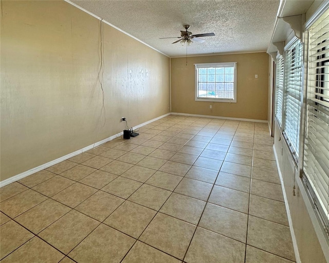 tiled spare room with crown molding, ceiling fan, and a textured ceiling