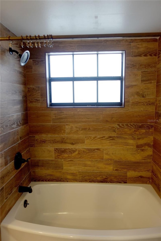 bathroom featuring tiled shower / bath and plenty of natural light