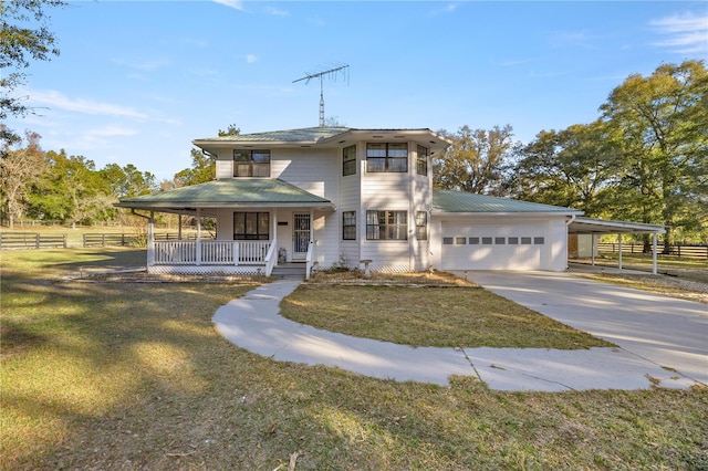 view of front of home featuring a garage, a front lawn, and a porch