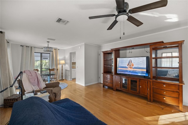 living room featuring crown molding, ceiling fan, and light hardwood / wood-style flooring