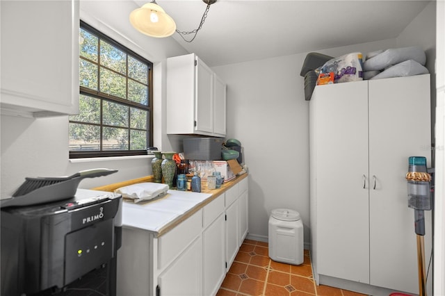 kitchen featuring white cabinetry and light tile patterned flooring