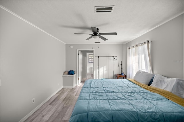 unfurnished bedroom featuring crown molding, ceiling fan, a textured ceiling, and light wood-type flooring