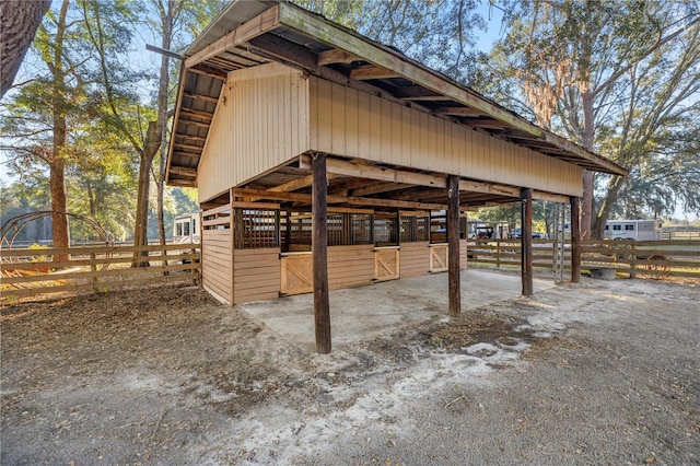 exterior space featuring an outdoor structure, a carport, and an exterior structure