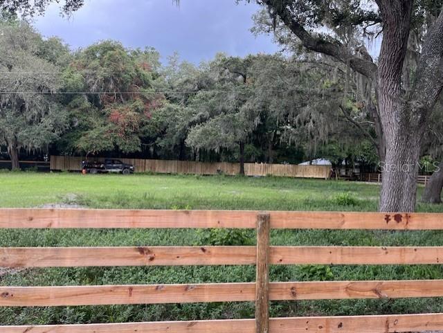 view of gate with a yard