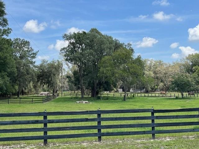 view of gate featuring a rural view and a yard