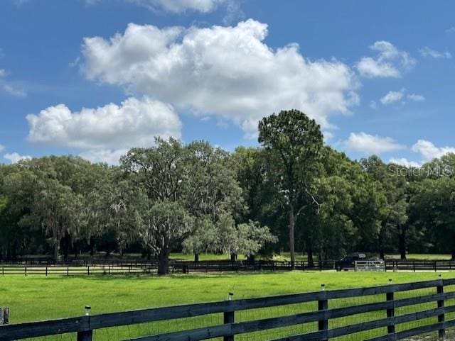 exterior space with a rural view and fence