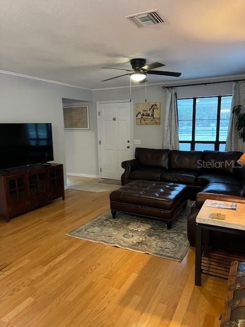 10245 SW 105th St, Ocala, FL 34481 - living area with crown molding, light wood-style floors, ceiling fan, and baseboards