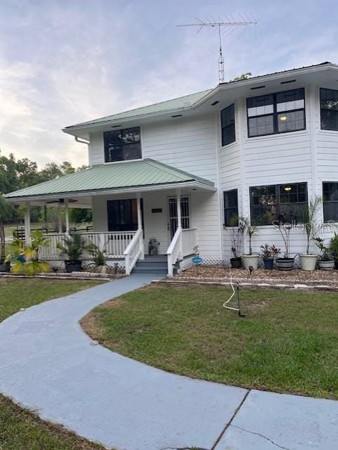 10245 SW 105th St, Ocala, FL 34481 - view of front of home featuring covered porch and a front lawn