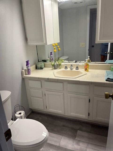 10245 SW 105th St, Ocala, FL 34481 - bathroom featuring toilet, vanity, and tile patterned floors